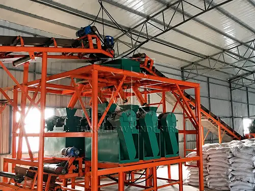 Full NPK fertilizer dry granulation production line with orange support frame in workshop